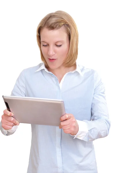 Beautiful young business woman looks astonished and surprised at her tablet pc — Stock Photo, Image