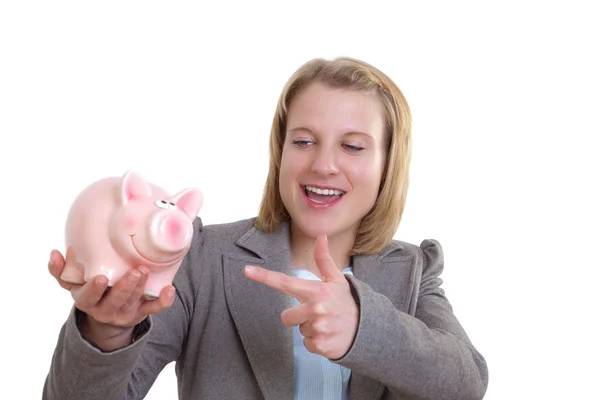 Young woman showing a piggy bank with her finger — Stock Photo, Image