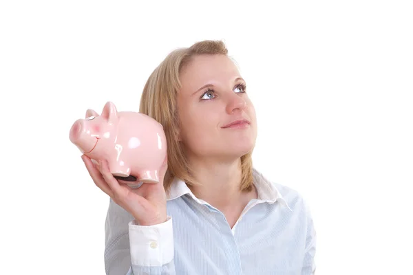 Pensive young woman with piggy bank looking up — Stock Photo, Image
