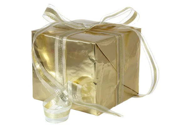 A big golden christmas gift with white ribbon on white background — Stock Photo, Image