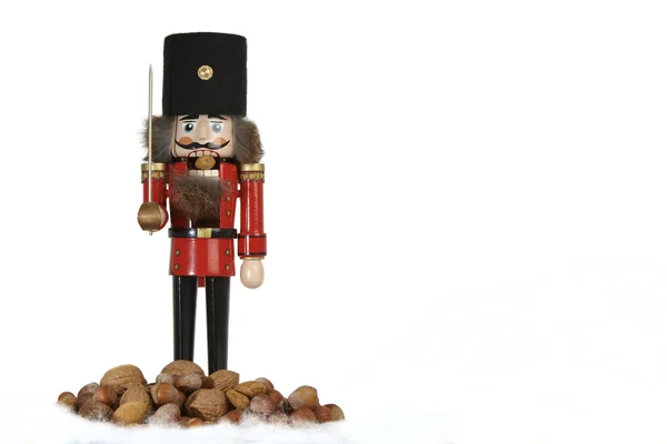 Traditional nutcracker with nuts on white background — Stock Photo, Image