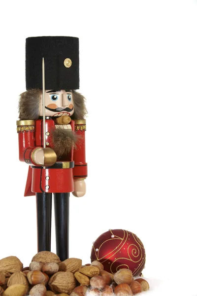 Traditional nutcracker with nuts on white background — Stock Photo, Image