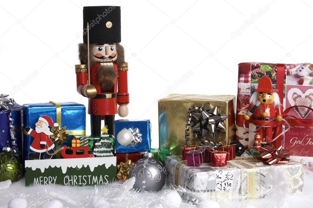Christmas decoration with gifts, christmas balls, wooden sign and nutcracker