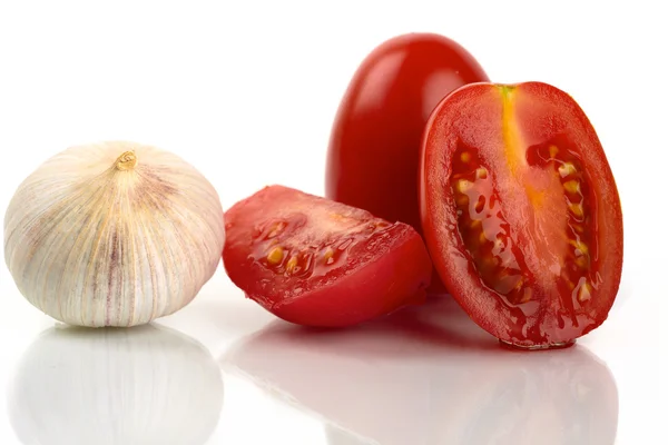 Färska tomater med vitlök lök på en vit bakgrund — Stockfoto