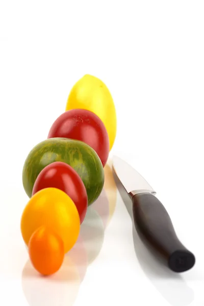 stock image Several organic tomatoes in series with a knife