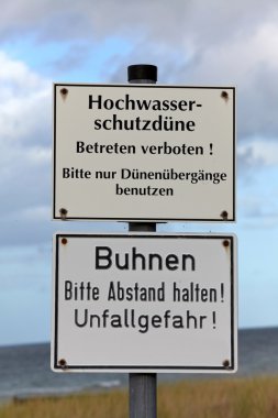 High water and groynes sign on the Baltic coast clipart