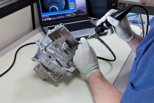 stock image Video endoscopy. An employee checks a part of a gear case with the video endoscope