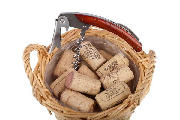 Corkscrew lies a basket with a lot of bottle corks — Stock Photo, Image