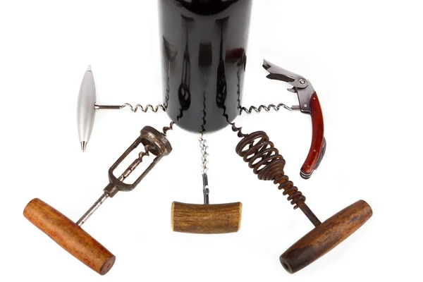 Some are different corkscrews around a wine bottle — Zdjęcie stockowe
