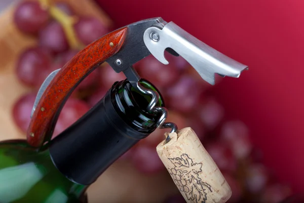 A corkscrew with cork on the top of bottleneck — Stock Photo, Image