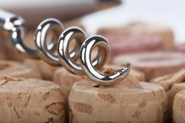 Close up of a corkscrew spiral lying on cork — Stock Photo, Image