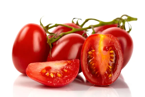 Fresh roma tomatoes cut in front of white background — Stock Photo, Image