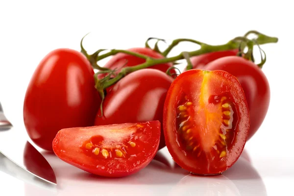 Fresh roma tomatoes cut in front of white background — Stock Photo, Image