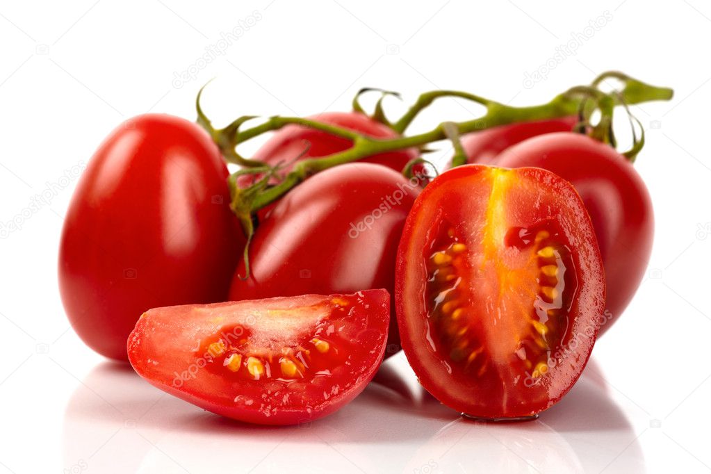 Fresh roma tomatoes cut in front of white background