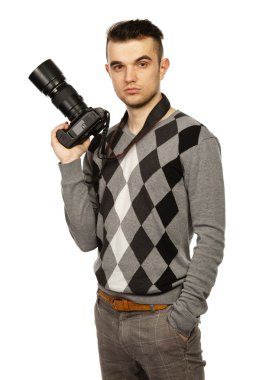 Young man with camera. Isolated over white background. clipart