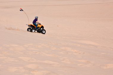 ATV in the sand dunes clipart