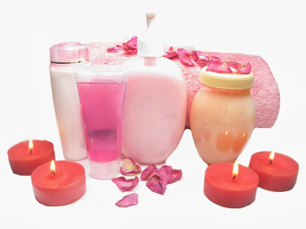 Spa rose petals cremes shampoo and candles — Stock Photo, Image