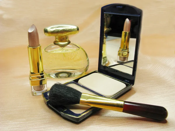 Brown lipstick powder and perfume bottle — Stock Photo, Image