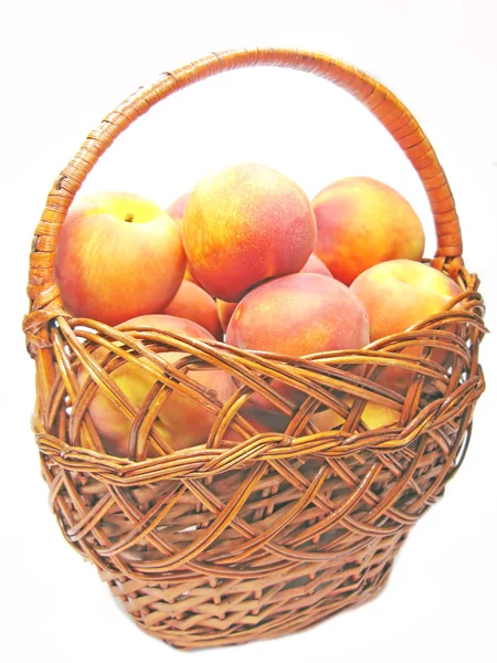 Basket full of peaches fruit — Stock Photo, Image