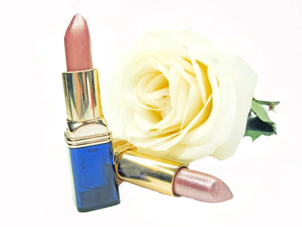 Two lipsticks with rose on background — Stock Photo, Image