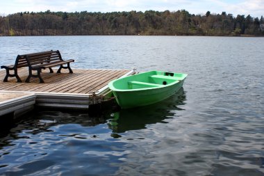 Landing stage with a boat clipart