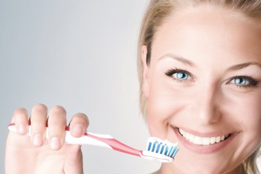 Happy Young Woman Brushing Her Teeth clipart