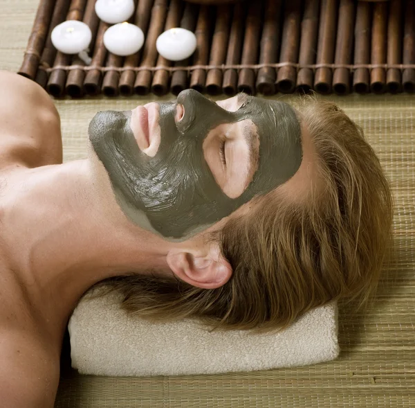 Spa. Handsome Man with a Mud Mask on his Face — Stock Photo, Image