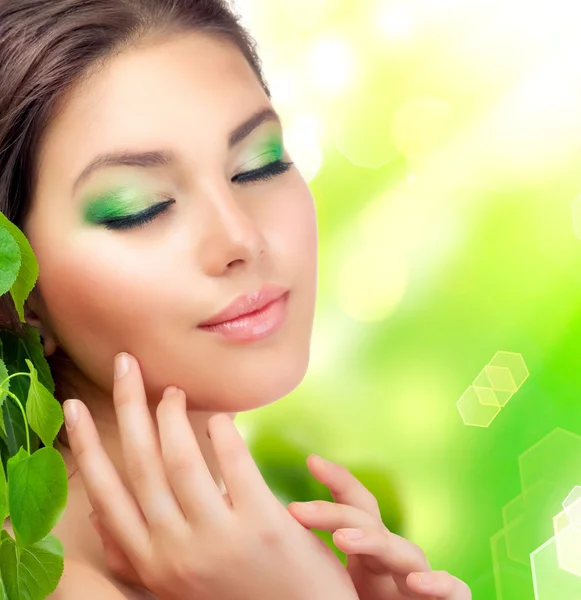 Beautiful Girl outdoors applying the natural cosmetics. Perfect Stock Photo