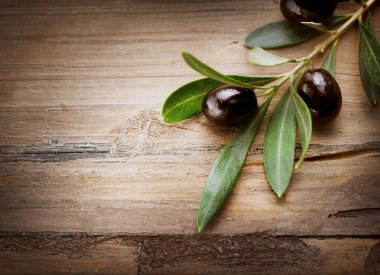 Olives over Wood Background clipart