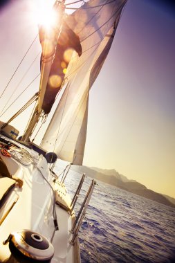 Yacht Sailing against sunset.Sailboat clipart