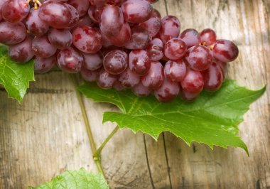 Bunch of grapes over Wood Background clipart