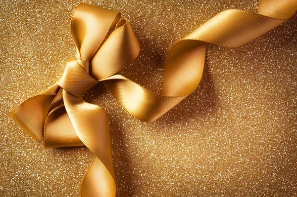 Urlaub background.greeting card.gold bow auf einem blinkenden backgrou — Stockfoto