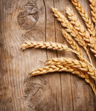 Wheat Ears on the Wood Background clipart