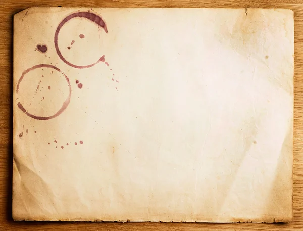 Old Paper Sheet With Stains Over Wooden Background — Stock Photo, Image