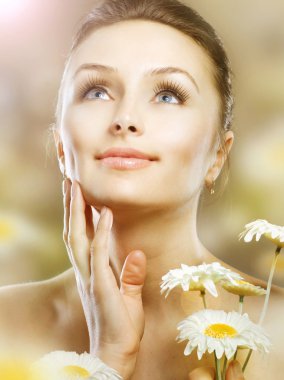 Skincare. Beautiful Spring Girl With Chamomile Flowers. Healthy clipart