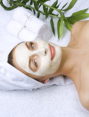 Beautiful Woman Getting Spa. Clay Facial Mask. Dayspa clipart