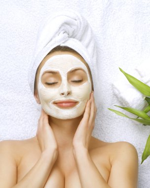 Spa Woman Applying Facial Cleansing Mask clipart