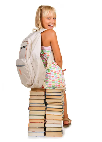 教育の概念。書籍のスタック上に座っている女子高生 — ストック写真