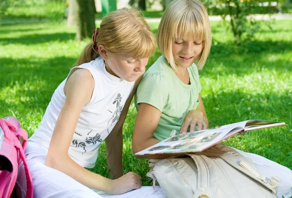 Duas meninas da escola lendo o livro ao ar livre — Fotografia de Stock