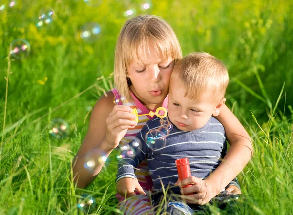 Happy Sister And Brother Blowing Soap Bubbles — Stock Photo, Image