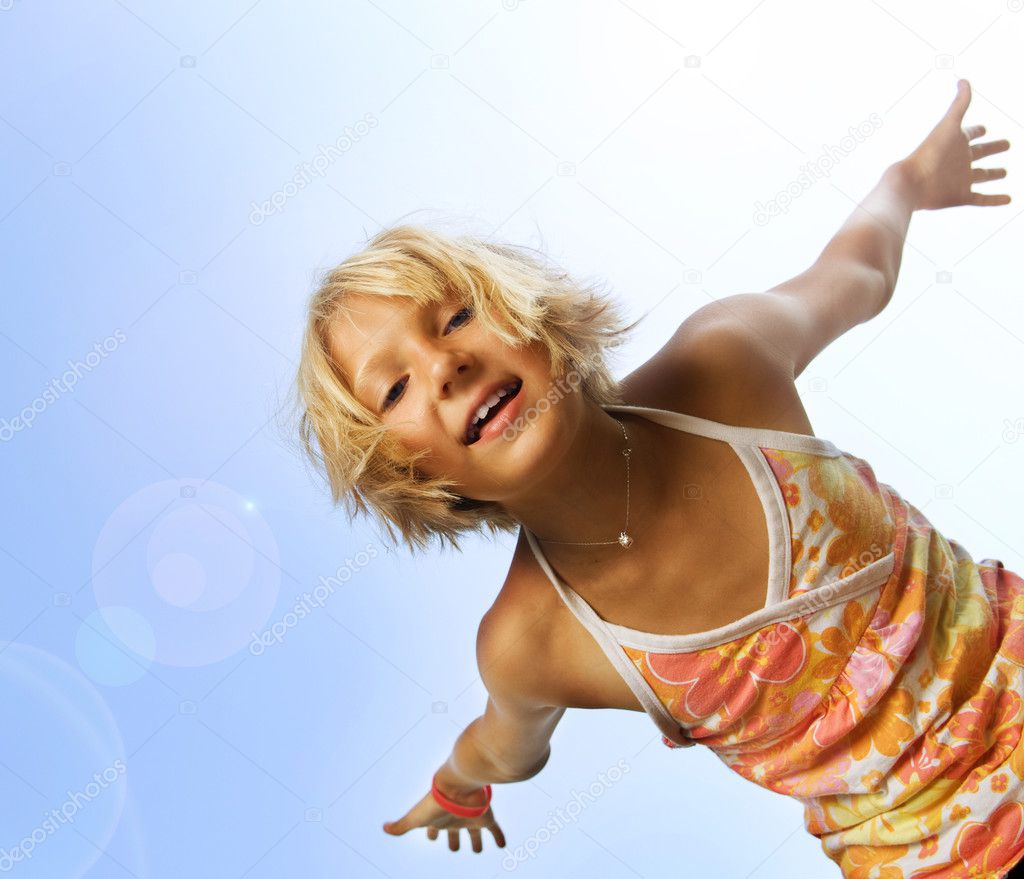 Happy Cute Little Girl Having Fun. Over Blue Sky