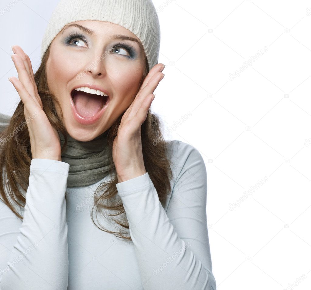 Happy Young Beautiful Woman. Surprised winter Girl over white