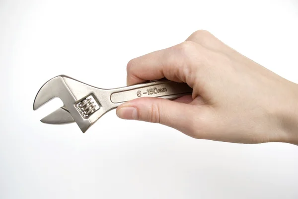 Hand mit einem Schraubenschlüssel — Stockfoto