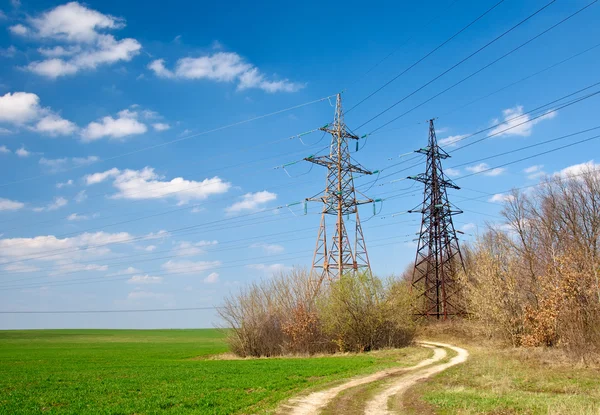 Two power tensions and lines near road — Stock Photo, Image