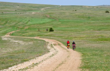 Mountain bicycle at sunny day on the road. clipart