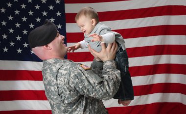 American Soldier holds his infant son clipart