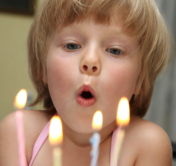 stock image Happy little blond girl blowing cake candle in a birthday party