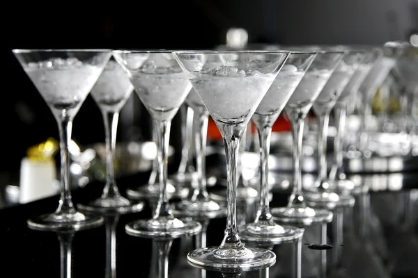 stock image Couple sitting at bar, cocktail glass in foreground