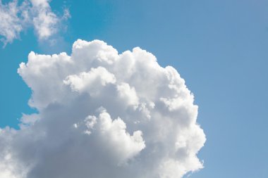 Fantastic soft white clouds against blue sky clipart