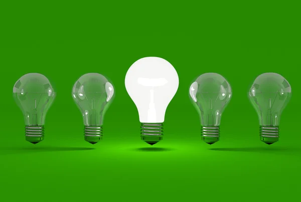 Algumas lâmpadas em um fundo verde Imagens De Bancos De Imagens Sem Royalties